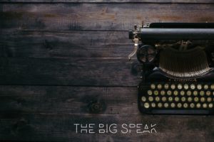 Vintage typewriter on dark wood — The Big Speak